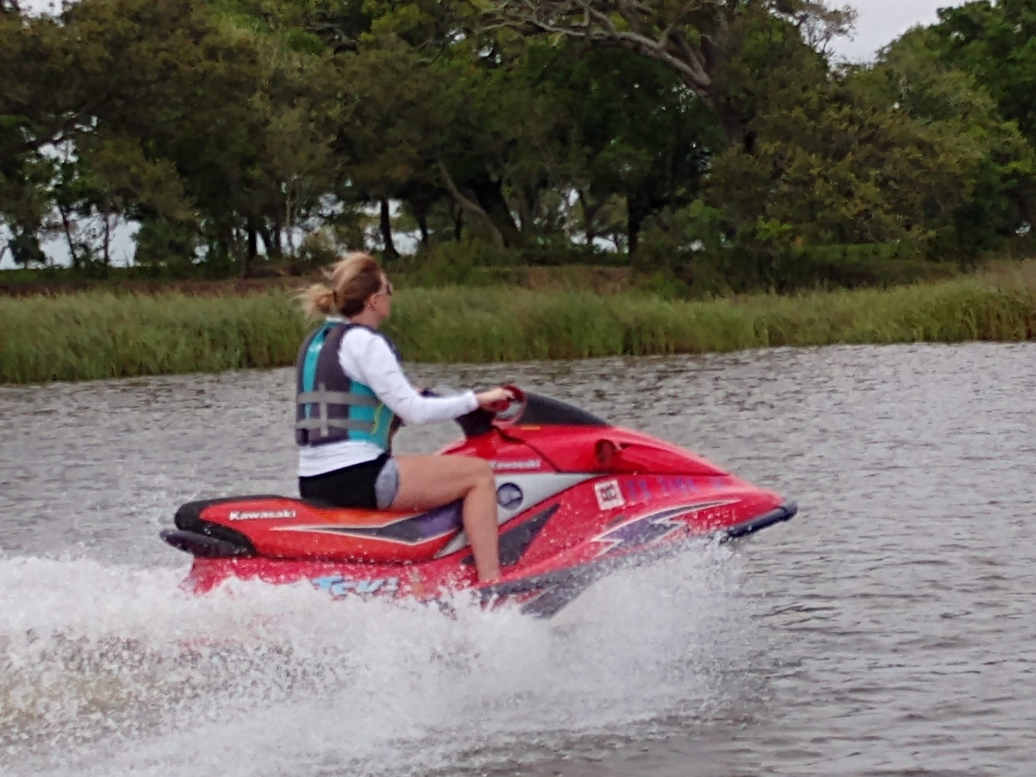 Woman Riding on Red Jet Ski on Lake