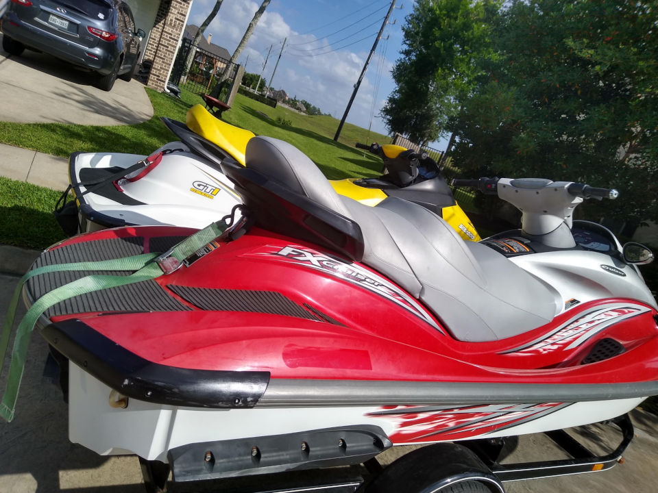 Pair of Affordable Jet Ski Rental Parked In Street